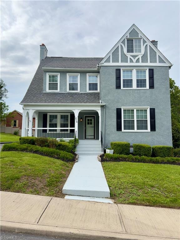 216 Rawley Ave, Mount Airy, NC 27030 - view of front of home featuring a chimney, covered porch, a front lawn, and stucco siding