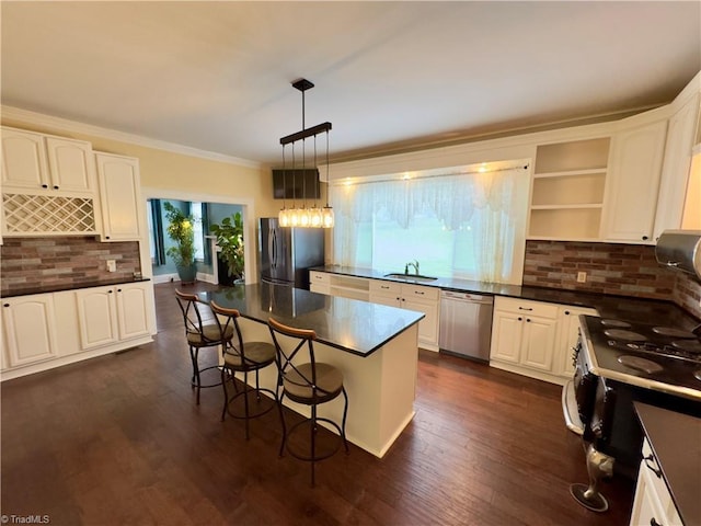 216 Rawley Ave, Mount Airy, NC 27030 - kitchen with stainless steel appliances, a sink, dark countertops, decorative backsplash, and crown molding