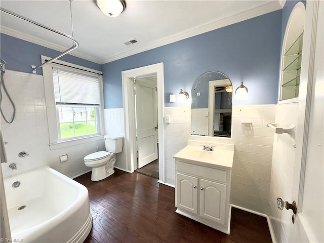 216 Rawley Ave, Mount Airy, NC 27030 - bathroom with tile walls, wood finished floors, toilet, vanity, and wainscoting