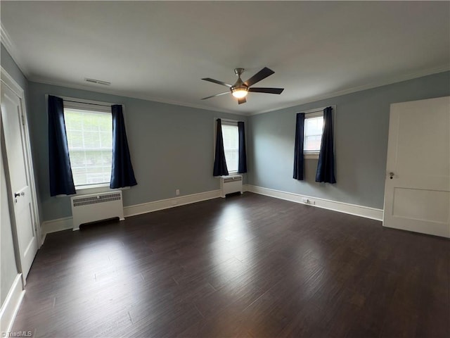216 Rawley Ave, Mount Airy, NC 27030 - spare room featuring radiator heating unit, ornamental molding, a ceiling fan, and dark wood-type flooring