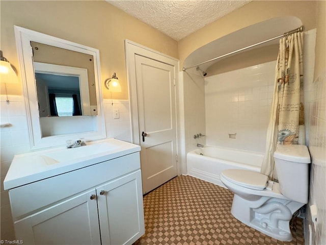 216 Rawley Ave, Mount Airy, NC 27030 - full bath with tile walls, toilet, shower / bath combination with curtain, vanity, and a wainscoted wall