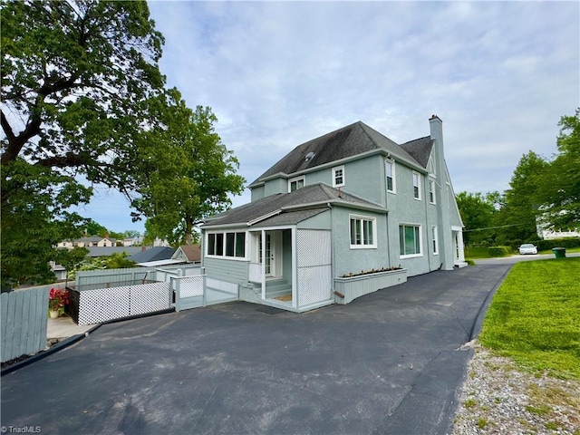 216 Rawley Ave, Mount Airy, NC 27030 - view of front facade with a shingled roof, a chimney, stucco siding, and entry steps