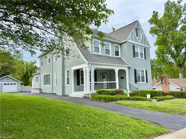 216 Rawley Ave, Mount Airy, NC 27030 - view of front facade with covered porch, stucco siding, and a front yard