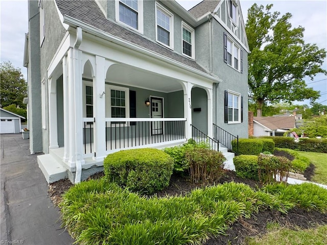 216 Rawley Ave, Mount Airy, NC 27030 - view of front facade with a porch, stucco siding, a shingled roof, and an outbuilding