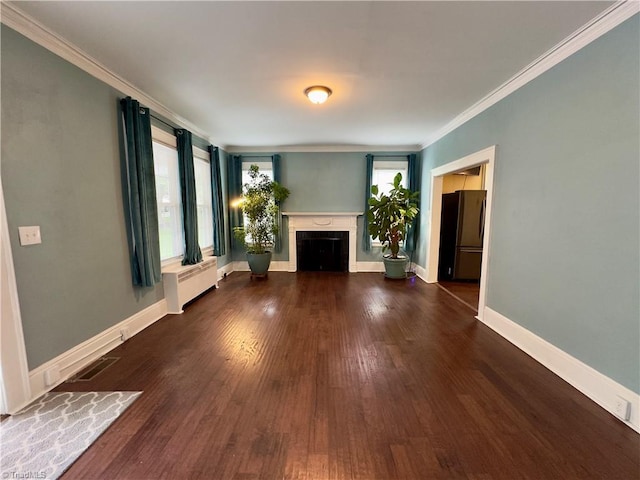 216 Rawley Ave, Mount Airy, NC 27030 - unfurnished living room featuring radiator heating unit, crown molding, a fireplace, wood finished floors, and baseboards