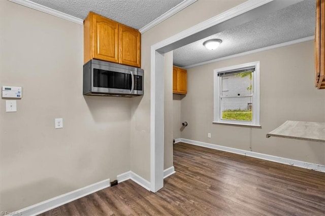 laundry area with baseboards, a textured ceiling, and dark wood-style flooring