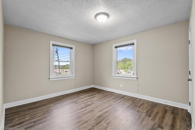 unfurnished room featuring a textured ceiling, baseboards, and dark wood-style flooring