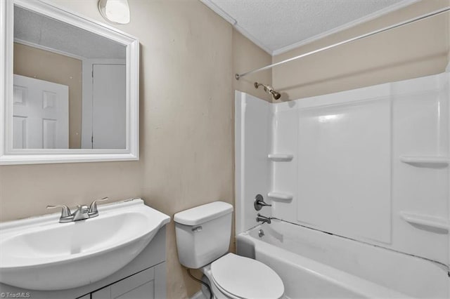 bathroom featuring washtub / shower combination, toilet, vanity, ornamental molding, and a textured ceiling