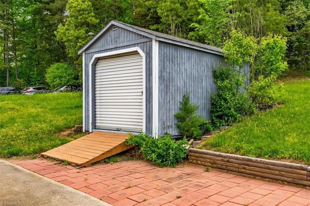 view of outbuilding featuring an outdoor structure and a forest view