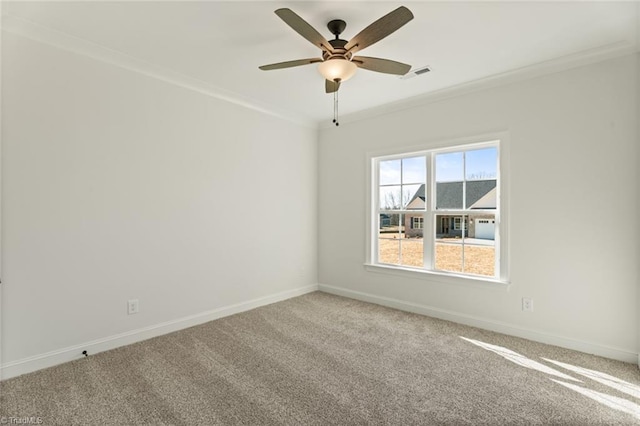 spare room featuring baseboards, visible vents, a ceiling fan, crown molding, and carpet floors