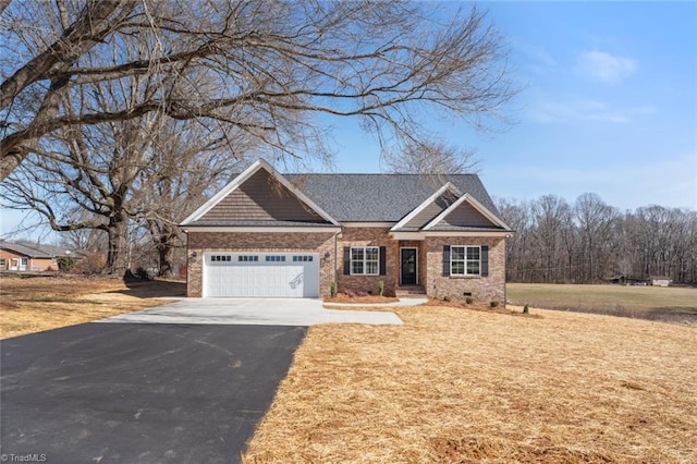 craftsman inspired home featuring driveway, brick siding, crawl space, and an attached garage