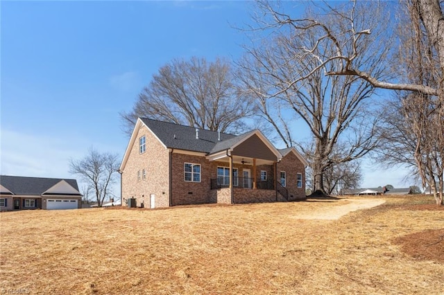 view of front of property featuring crawl space, a front lawn, a porch, and brick siding