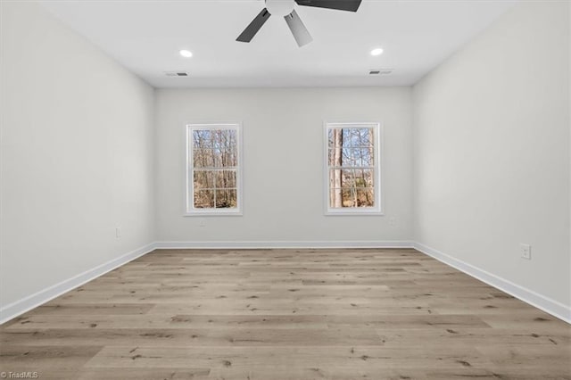 spare room featuring recessed lighting, wood finished floors, visible vents, and baseboards