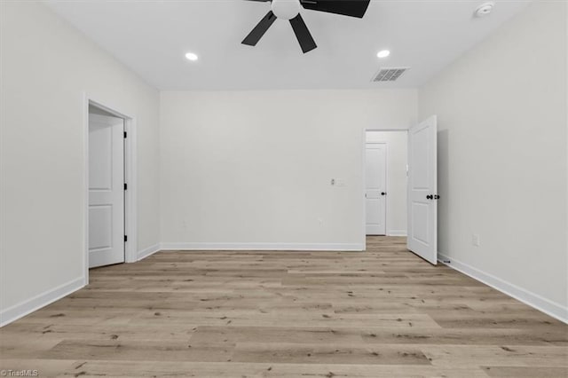 empty room with recessed lighting, visible vents, baseboards, and light wood finished floors