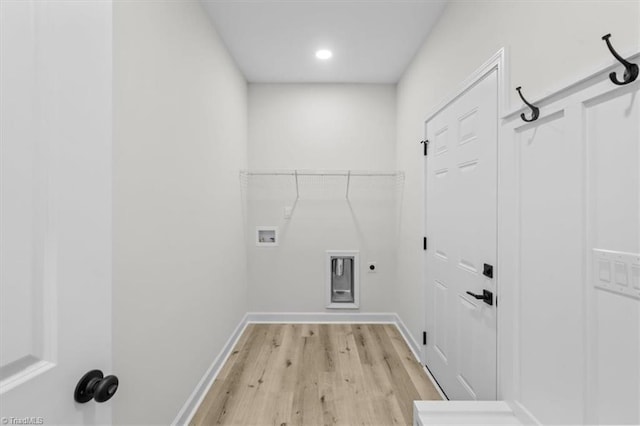 washroom featuring baseboards, laundry area, light wood-style flooring, electric dryer hookup, and washer hookup