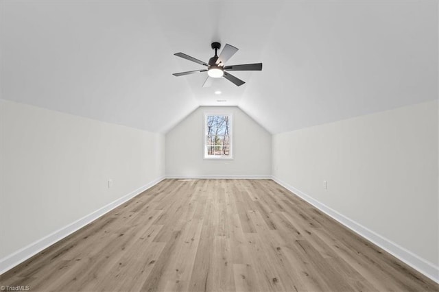 bonus room with vaulted ceiling, ceiling fan, baseboards, and wood finished floors