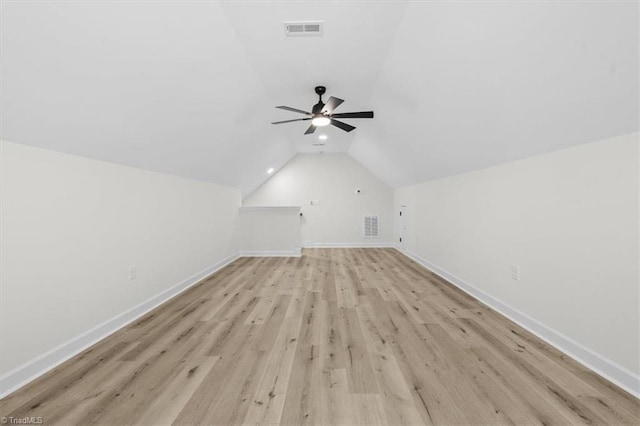 bonus room with visible vents, baseboards, light wood-type flooring, and lofted ceiling