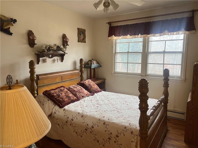 bedroom featuring ceiling fan, hardwood / wood-style floors, multiple windows, and a baseboard radiator