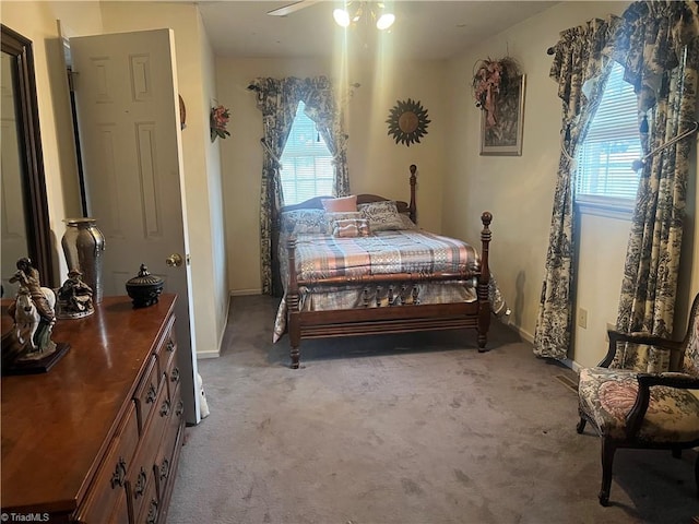 bedroom with ceiling fan and light carpet