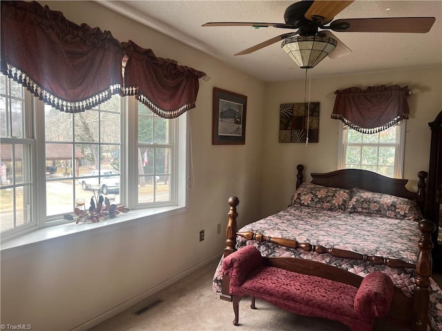 bedroom with ceiling fan and carpet flooring