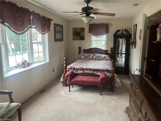 bedroom with ceiling fan and light colored carpet