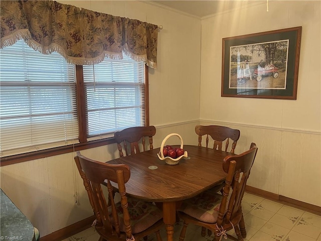 tiled dining space featuring ornamental molding