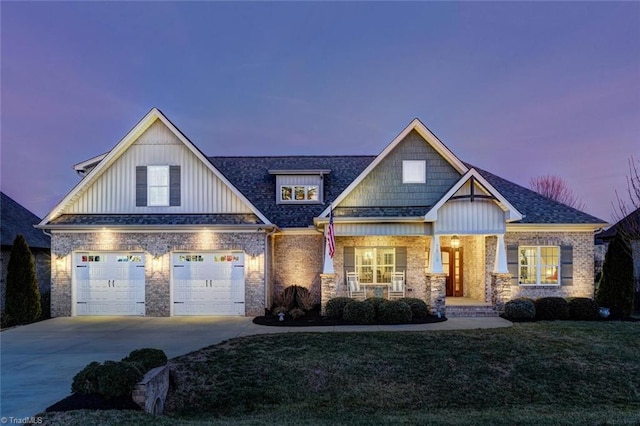 craftsman inspired home featuring a garage, a porch, and a lawn