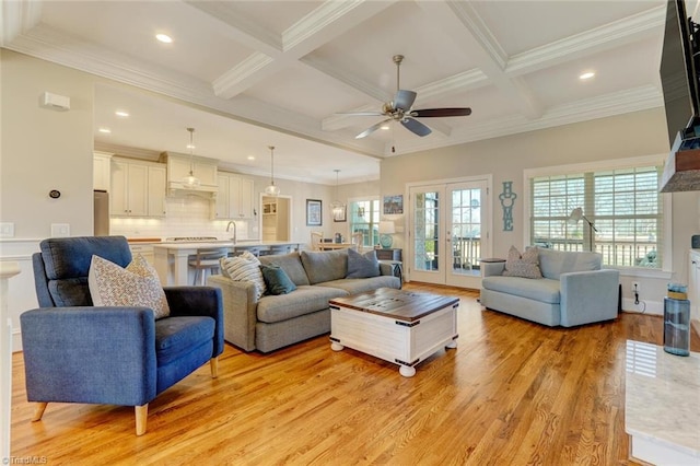 living room with coffered ceiling, light hardwood / wood-style flooring, beam ceiling, and french doors