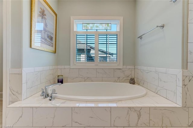 bathroom featuring tiled tub