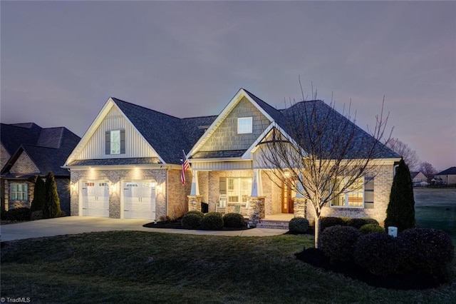 view of front facade featuring a garage and a lawn