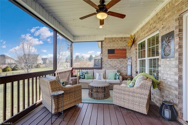 sunroom featuring ceiling fan