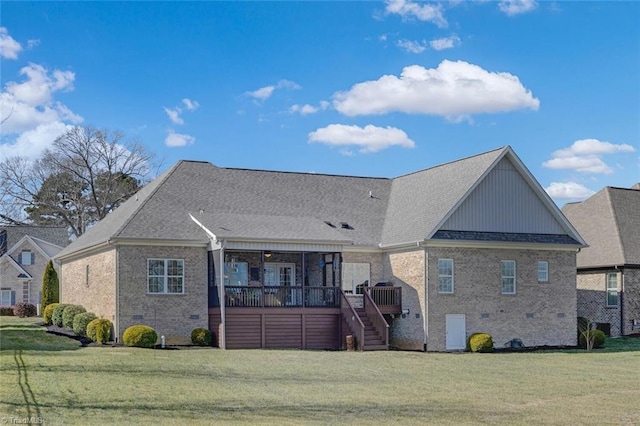 rear view of property featuring a yard and a deck