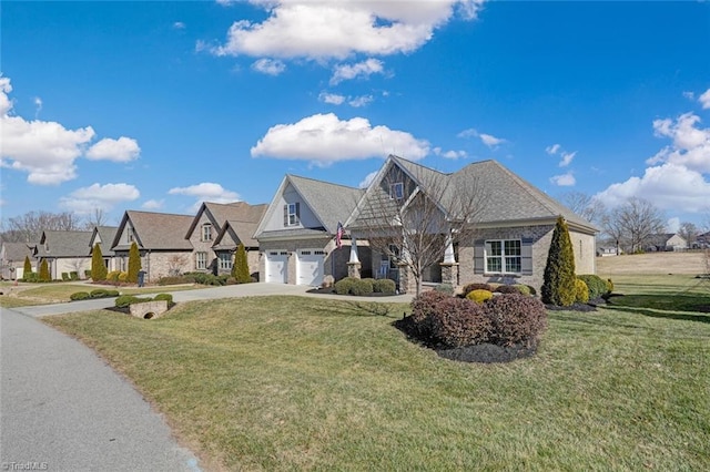 view of front of house featuring a garage and a front lawn