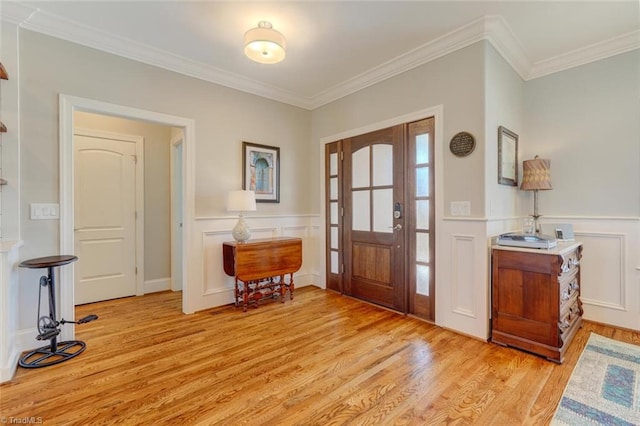 entrance foyer with crown molding and light hardwood / wood-style floors