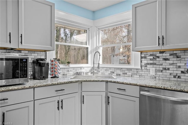 kitchen with sink, white cabinets, and appliances with stainless steel finishes