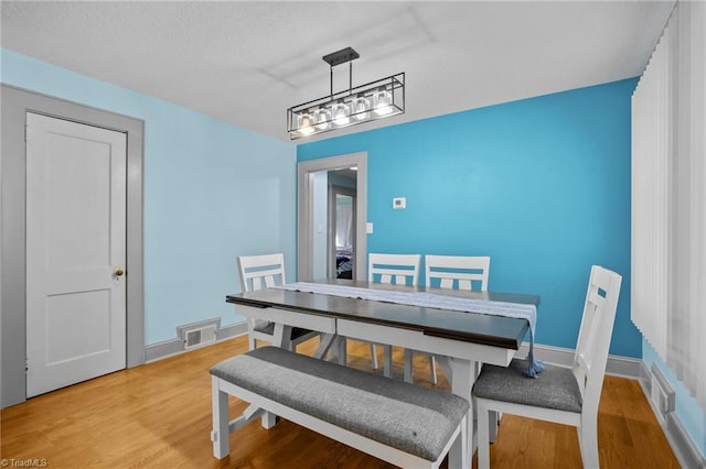 dining area with hardwood / wood-style floors