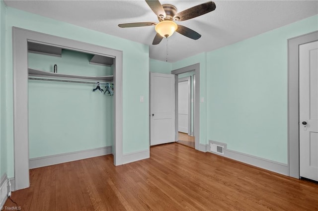 unfurnished bedroom with a closet, ceiling fan, and light hardwood / wood-style flooring