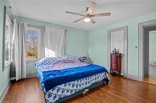 bedroom with wood-type flooring and ceiling fan