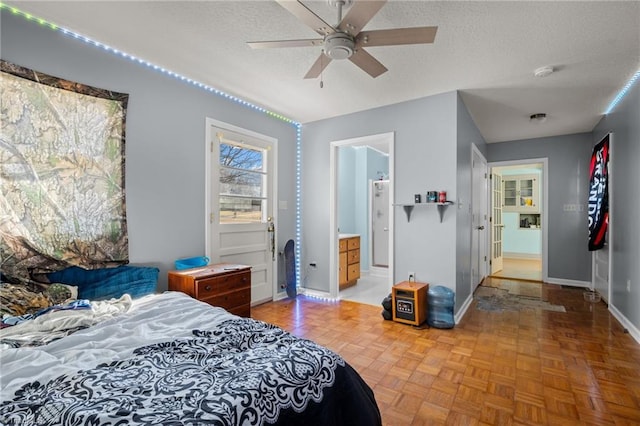 bedroom with ceiling fan, parquet flooring, and a textured ceiling