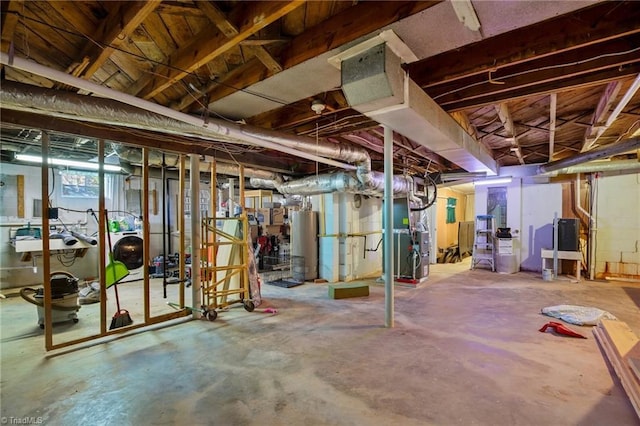 basement with water heater, washer / dryer, and heating unit