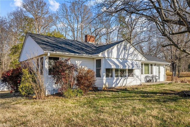 view of side of home featuring a lawn