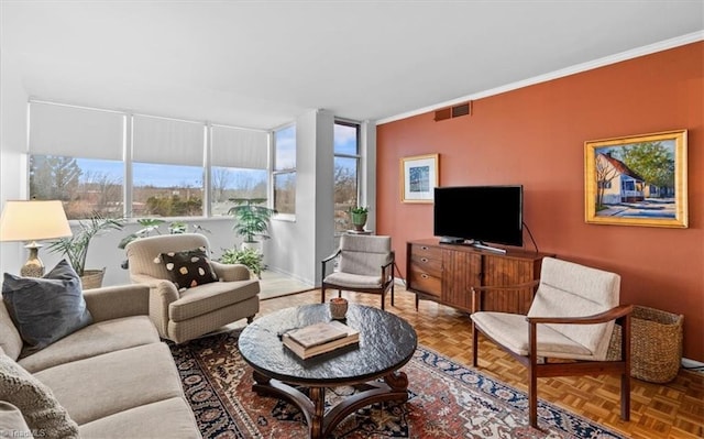 living room with crown molding and parquet flooring