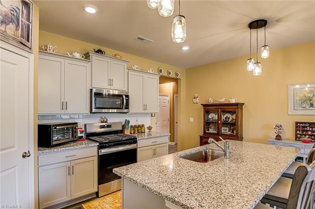 416 Bryson Blvd, Lexington, NC 27295 - kitchen with stainless steel appliances, a breakfast bar, decorative light fixtures, light stone counters, and recessed lighting