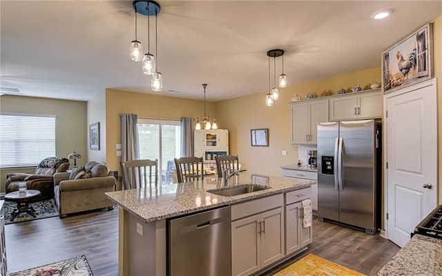 416 Bryson Blvd, Lexington, NC 27295 - kitchen featuring stainless steel appliances, dark wood finished floors, a kitchen island with sink, open floor plan, and decorative light fixtures