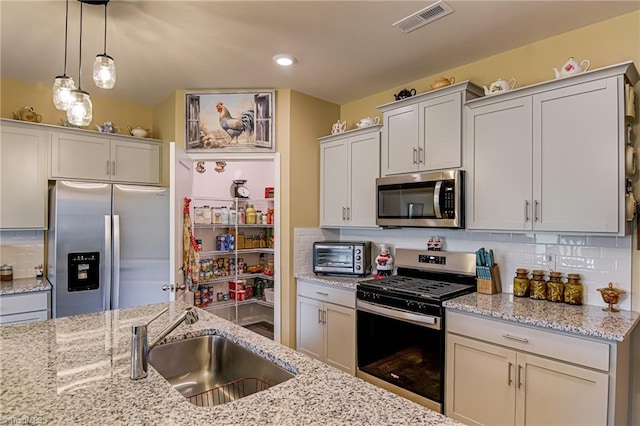 416 Bryson Blvd, Lexington, NC 27295 - kitchen with appliances with stainless steel finishes, backsplash, decorative light fixtures, light stone countertops, and recessed lighting