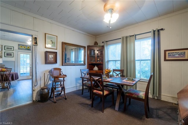 dining area with carpet floors and ornamental molding