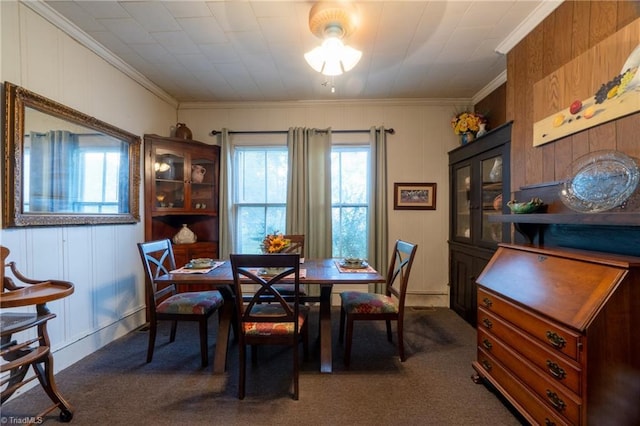 dining room featuring crown molding and carpet flooring