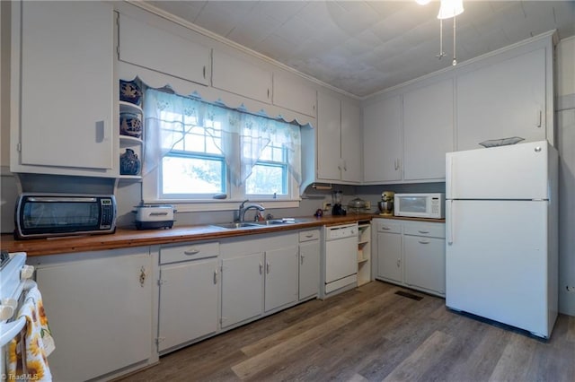 kitchen with white cabinetry, ornamental molding, sink, and white appliances