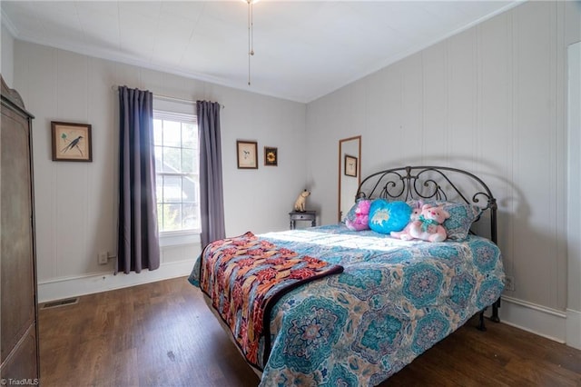 bedroom featuring crown molding and dark hardwood / wood-style floors