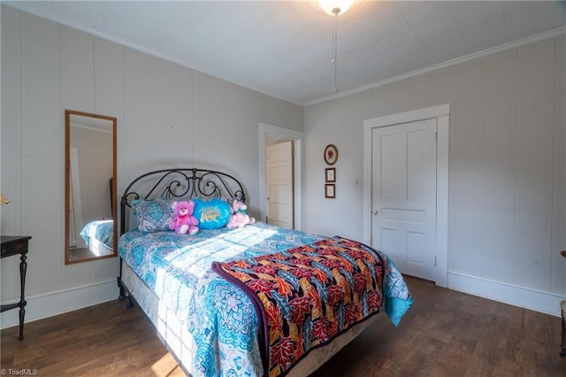 bedroom with ornamental molding, dark hardwood / wood-style flooring, and a closet